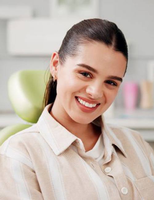 Smiling patient in dental treatment chair