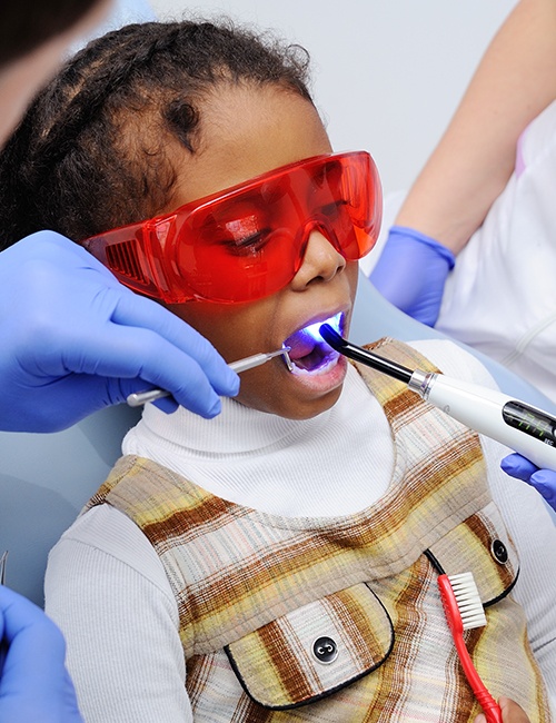 Child receiving dental sealants