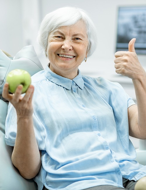 Woman with new dentures smiling