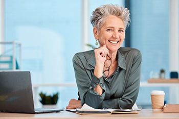 Woman smiling at desk in office