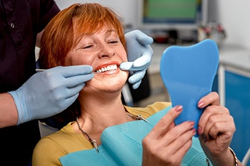 woman smiling after getting dentures in Copperas Coves