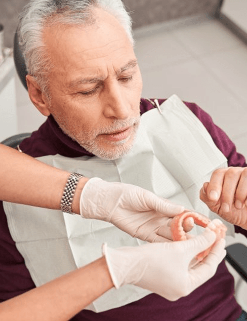 a patient in Copperas Cove receiving his new dentures 