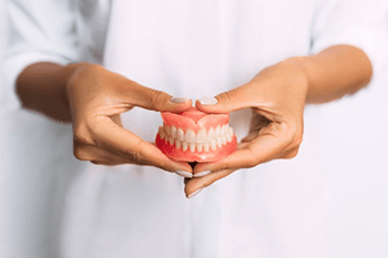 a person holding a pair of dentures in Copperas Cove