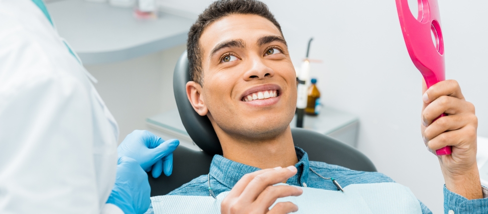 Dentist talking to man in dental chair