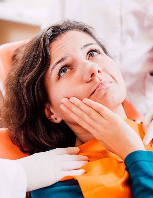 Pained woman visiting her Copperas Cove emergency dentist