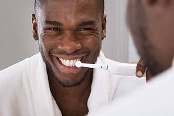 Man brushing his teeth to prevent dental emergencies in Copperas Cove