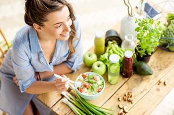 Woman eating healthy to prevent dental emergencies in Copperas Cove