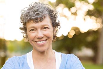 woman smiling after getting dental implants in coppers cove