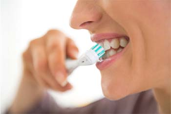 patients with dental implants in Copperas Cove brushing their teeth