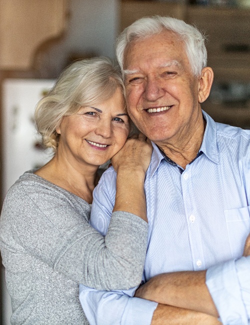 Senior couple with implant dentures in Copperas Cove, TX standing and smiling