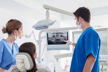 dentist showing a patient their X-rays