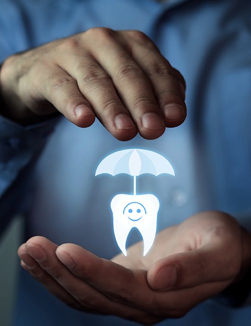 Hands holding an animated tooth under an umbrella