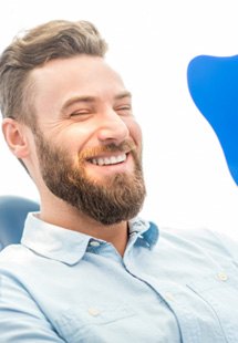 man smiling in dental mirror 