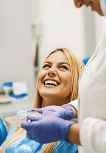 woman smiling while visiting dentist