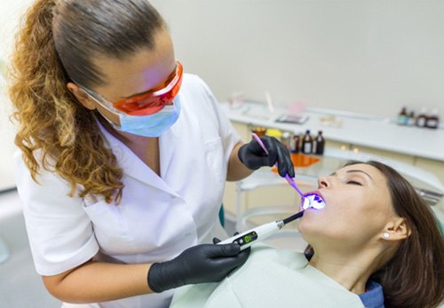 A dentist treating a sedated patient