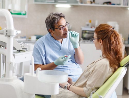 A dentist talking with his patient about oral conscious sedation