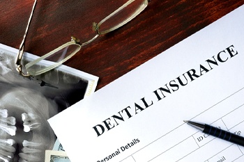 Dental insurance paperwork on wooden desk