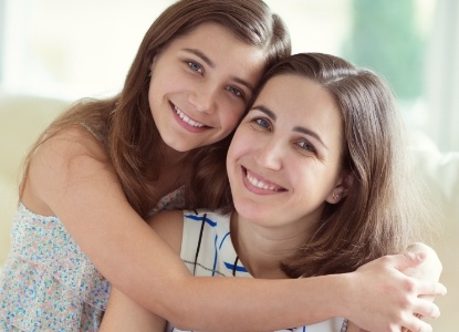 Mother and daughter smiling after children's dentistry