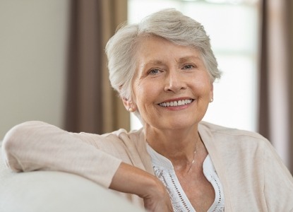 Older woman with healthy teeth and gums after periodontal therapy