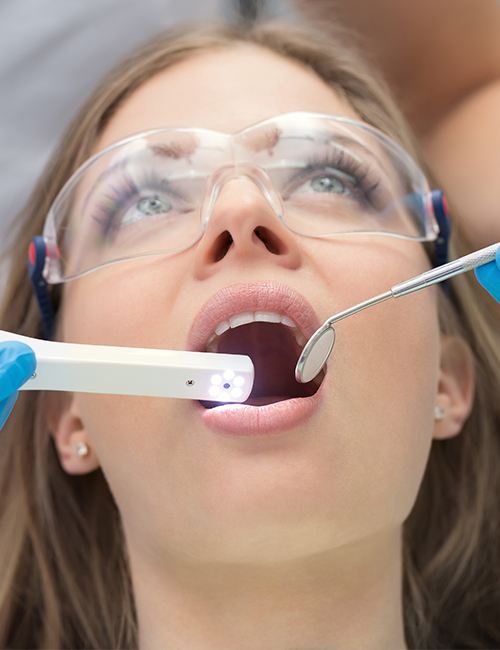 Dentist using intraoral camera to capture images