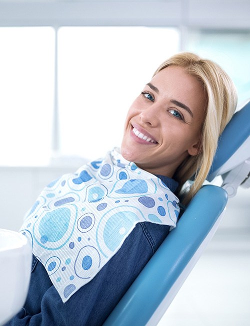 Smiling woman in dentist’s chair