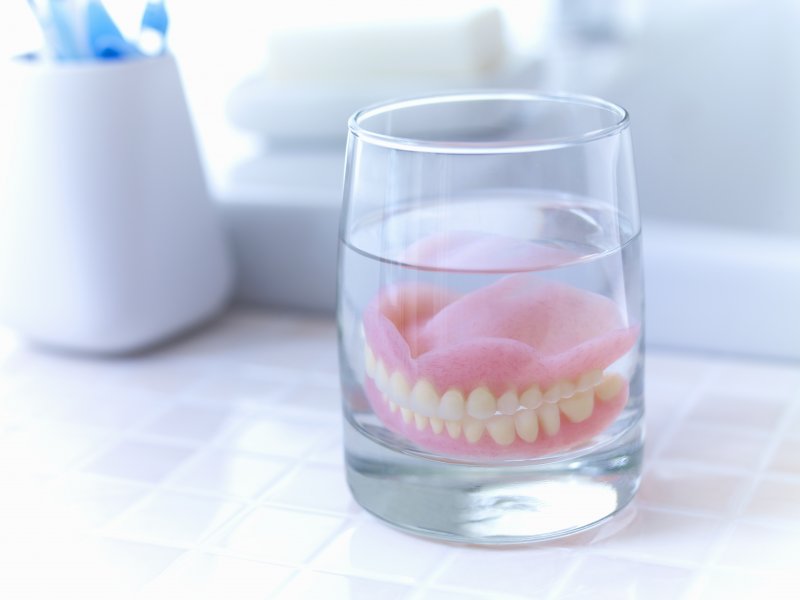 dentures soaking in a glass overnight