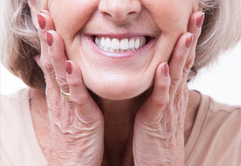 patient smiling while wearing ill-fitting dentures