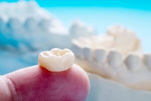 Dental crown with bite impression in the background. 