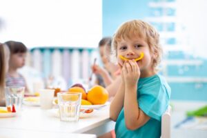 Child eating a healthy snack happily