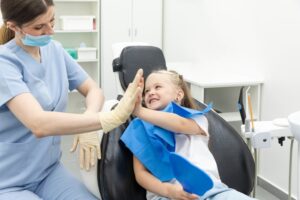Dentist high-fiving her child patient for having healthy teeth