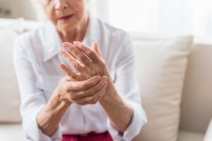 Elder woman with arthritis in hands. 