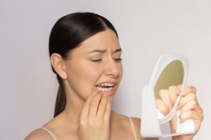 Woman looking at her swollen gums