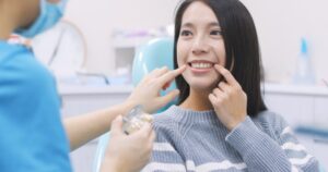 Woman talking to her dentist about teeth whitening