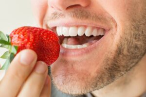 Man eating strawberries